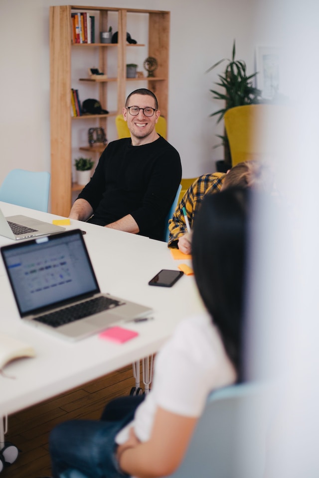 smiling person in an office board meeting