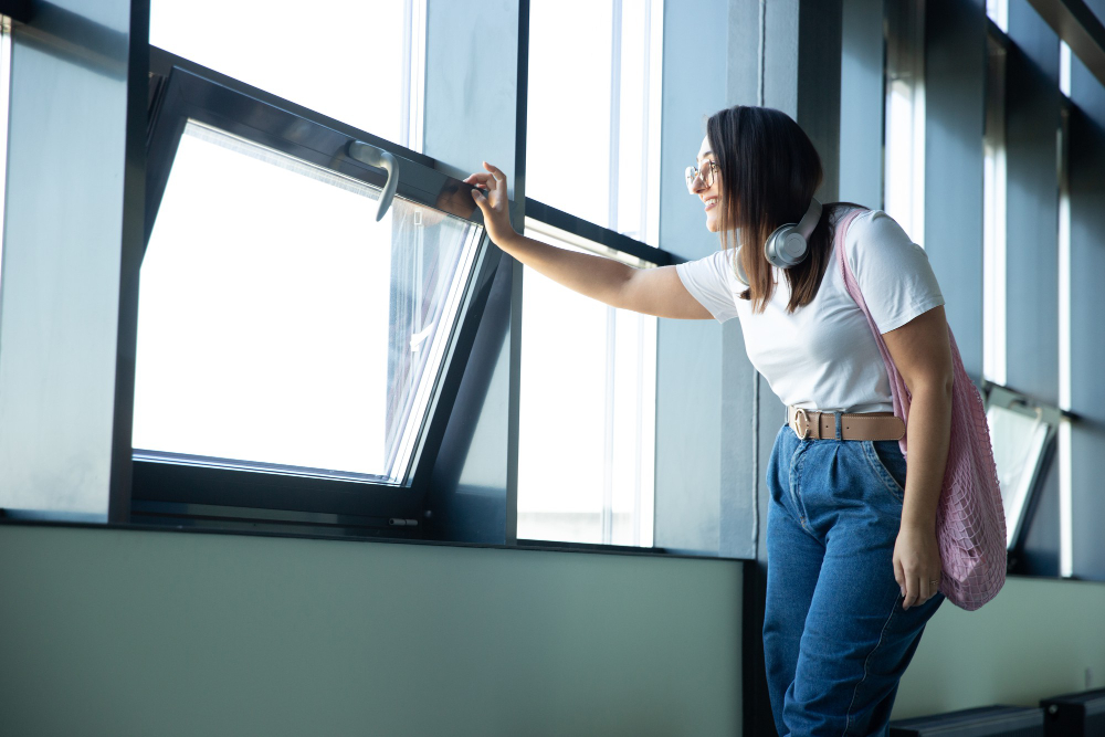 woman looking outside open triple glazing in Glasgow